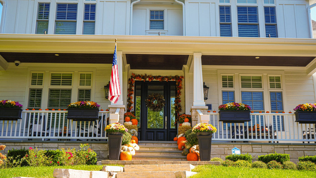 Professional fall porch display with pumpkins and mums on a North Shore home