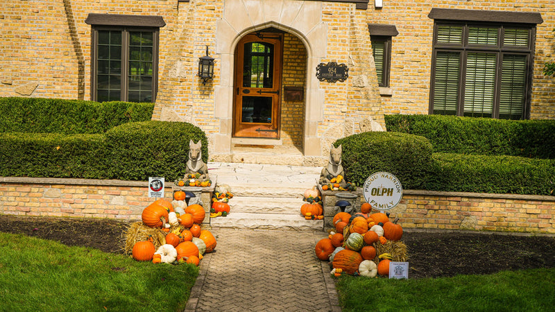 Signature fall porch display with a symmetric, formally balanced front entry